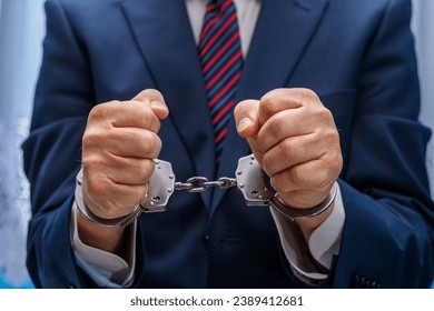 1134_elegantly-dressed-man-suit-handcuffs-260nw-2389412681.jpg